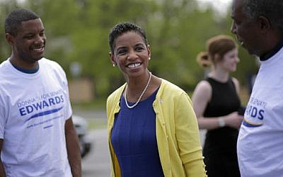 Democratic U.S. Senate candidate, Rep. Donna Edwards, D-Md., center, and her son Jared, back left, greet volunteers outside a polling place at Winfield Elementary School in Windsor Mill, Md., Tuesday, April 26, 2016. (AP Photo/Patrick Semansky)
