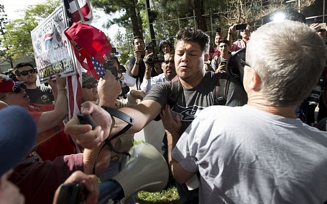 A man, center, sprays Republican presidential candidate Donald Trump supporters with pepper spray during a rally in front of the Anaheim City Hall on Tuesday, April 26, 2016, in Anaheim, Calif. (Leonard Ortiz/The Orange County Register via AP) A man, center, sprays Republican presidential candidate Donald Trump supporters with pepper spray during a rally in front of the Anaheim City Hall on Tuesday, April 26, 2016, in Anaheim, Calif. (Leonard Ortiz/The Orange County Register via AP)