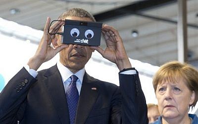 German Chancellor Angela Merkel looks on as US President Barack Obama tests VR goggles when touring the Hannover Messe, the world's largest industrial technology trade fair, in Hannover, northern Germany, Monday, April 25, 2016. (AP/Carolyn Kaster)