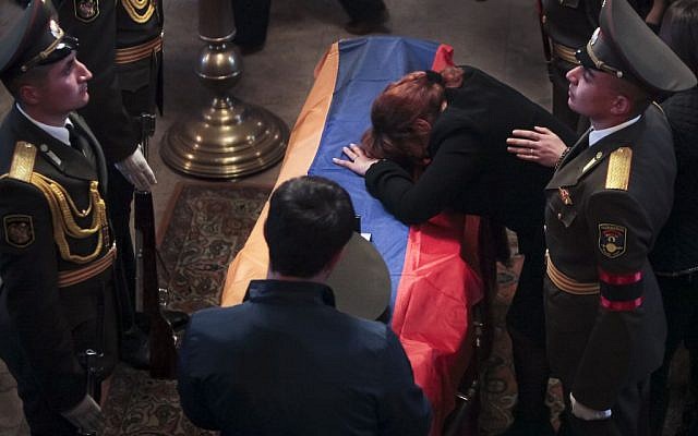 Mother of Karabakh military officer Armenak Urfanyan grieves at a coffin with the body of her son who was killed in fighting around Nagorno-Karabakh, during a funeral ceremony in a church in Yerevan, Armenia, April 5, 2016. (Aram Kirakosyan/PAN via AP) 