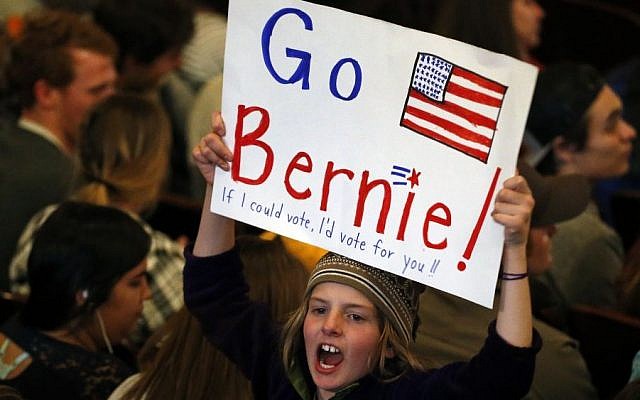 Marlow Mittelstaedt holds a sign and cheers while waiting for the arrival of Democratic presidential candidate Sen. Bernie Sanders, I-Vt., before a campaign rally in Laramie, Wyo., Tuesday, April 5, 2016. (AP/Brennan Linsley)