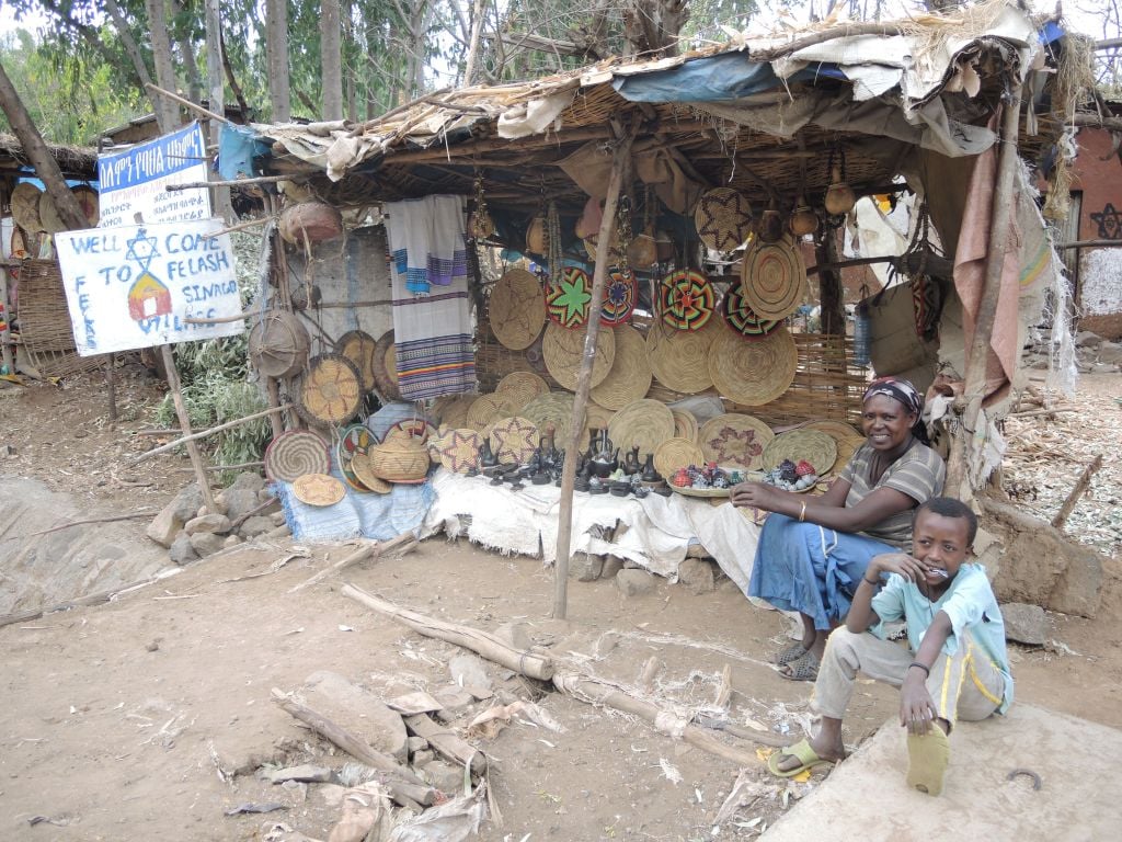 A resident and her son in their tourism stall at the entrance of Wolleka village, an abandoned Jewish village in Gondar, Ethiopia, that has become a tourism destination, on April 24, 2016. (Melanie Lidman/Times of Israel) A resident and her son in their tourism stall at the entrance of Wolleka village, an abandoned Jewish village in Gondar, Ethiopia, that has become a tourism destination, on April 24, 2016. (Melanie Lidman/Times of Israel)