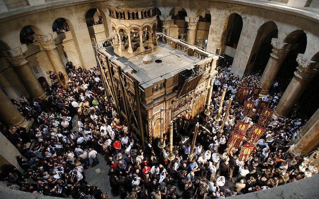 Orthodox Christians hold candles as worshipers gather around the Edicule at the Church of the Holy Sepulcher, traditionally believed to be the burial place of Jesus Christ, during the ceremony of the Holy Fire in Jerusalem's Old City, April 7, 2007. (Nati Shohat /Flash90)