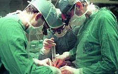 Illustrative: Doctors at Hadassah Hospital Ein Kerem performing surgery, Jerusalem, March 5, 1990. (Nati Shohat/Flash90/File)