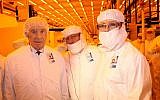 Former president Shimon Peres, left, and Intel employees at a Kiryat Gat chip factory in 2012. (Sivan Faraj/FLASH90)