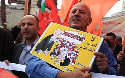 Palestinian supporters of Democratic Front for the Liberation of Palestine (DFLP) chant slogans during a demonstration against Israeli-Palestinian negotiations, in the West Bank city of Ramallah March 19, 2014. Photo By Issam Rimawi/Flash 90.