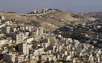 The security barrier seen in the background of the East Jerusalem neighborhood of Ras al-Amud, October 2014. (Miriam Alster/Flash90)