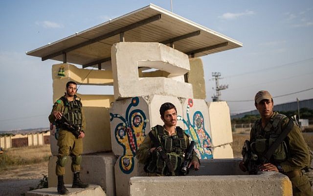 Israeli soldiers guard a post in the Israeli kibbutz of Netiv Ha'asara near the Gaza Strip on April 05, 2016. (Corinna Kern/Flash90)