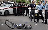 Police at the scene of an accident where a public bus hit and killed a young boy who was riding his bicycle in Jerusalem on April 10, 2016 (Yonatan Sindel/Flash90)