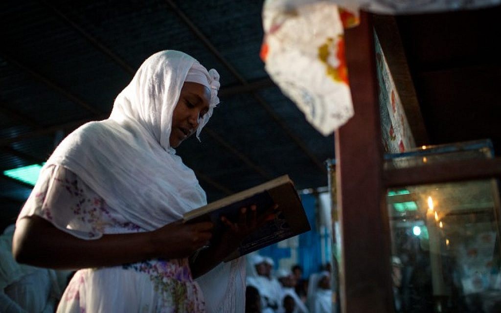 A member of the Falash Mura Jewish Ethiopian community lights the Sabbath candles before the Sabbath and Passover prayer service  in the synagogue in Gondar, Ethiopia, April 22, 2016. (Miriam Alster/FLASH90)