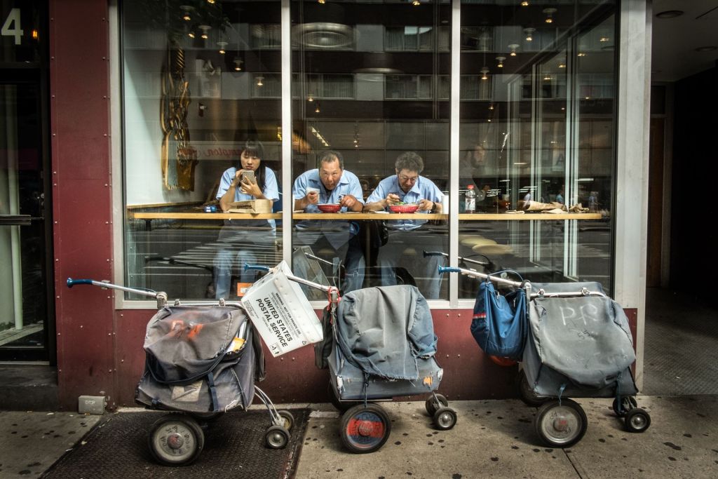 Even mail carriers take a break for lunch; a photograph on display at the Sarona Market exhibit 'Food Processor III' (Courtesy Dan Haimovich)