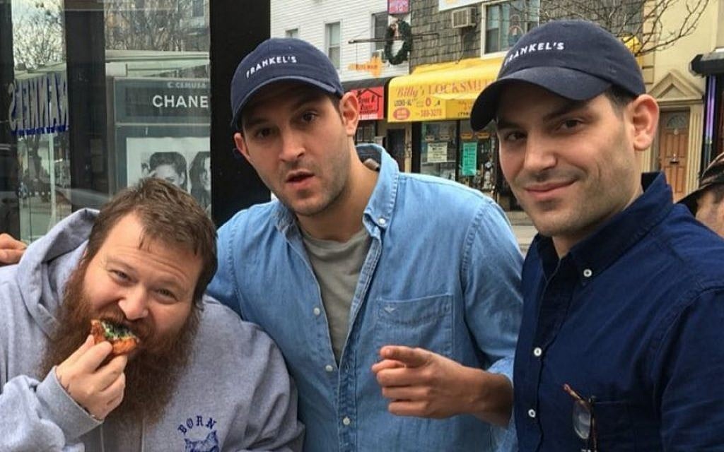 Rapper Action Bronson, left, chowing down on some Frankel's fare with the Frankel brothers, Zach, right, and Alex in front of their New York deli. (Screenshot from Instagram/via JTA) Rapper Action Bronson, left, chowing down on some Frankel's fare with the Frankel brothers, Zach, right, and Alex in front of their New York deli. (Screenshot from Instagram/via JTA)