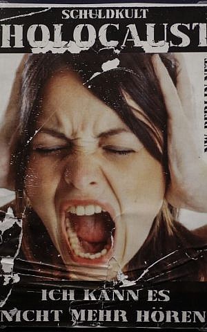 A sticker from around 2011 reading: 'Cult of Guilt: Holocaust - I can't hear it anymore!' displayed at an exhibition of antisemitic and racist stickers at the Deutsches Historisches Museum in Berlin, Germany, April 19, 2016. (AP Photo/Markus Schreiber)
