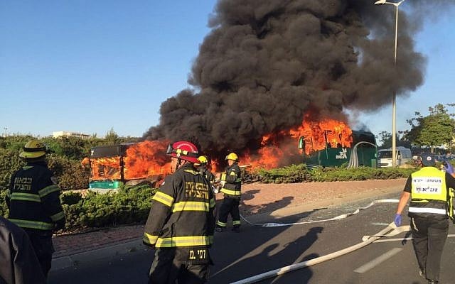 Firefighters look on as two buses burn in Jerusalem. Police launched an investigation into the incident, April 18, 2016. (Israel Police) Firefighters look on as two buses burn in Jerusalem. Police launched an investigation into the incident, April 18, 2016. (Israel Police)