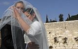 Groom and bride take wedding pictures at the Western Wall in the Old City of Jerusalem. April 13, 2011. (Nati Shohat/Flash90)