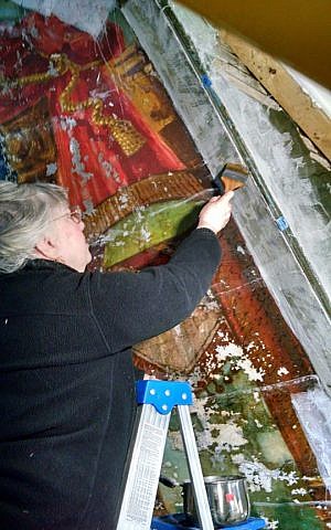 Constance Silver carefully restoring the Lost Shul Mural in Burlington, Vermont (courtesy)