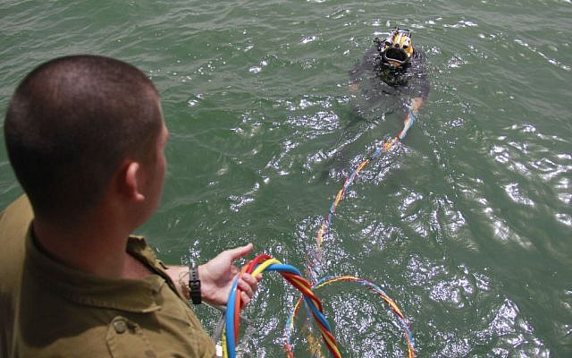 Cpl. Sahar Nitzan begins his descent to the bottom of the Sea of Galilee to search for missing pilot Lt. Yakir Naveh, whose plane crashed in 1962, on April 6, 2016. (Judah Ari Gross/Times of Israel)