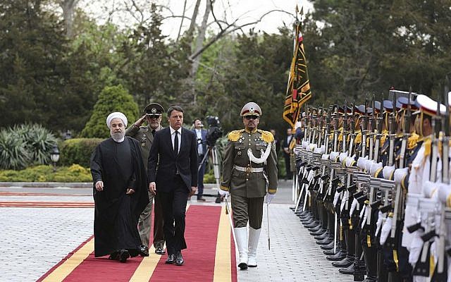 Italian Prime Minister Matteo Renzi reviews an honor guard as he is accompanied by Iran's President Hassan Rouhani during his official arrival ceremony at the Saadabad Palace in Tehran, Iran, Tuesday, April 12, 2016. (Iranian Presidency Office via AP)