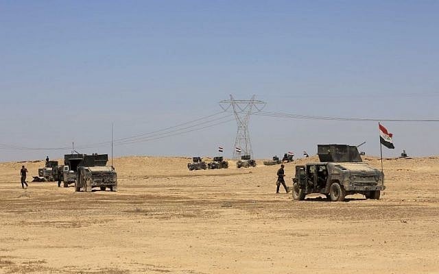 Iraq's elite counter terrorism forces advance through soft desert terrain outside the western Islamic State held town of Hit, 85 miles (140 kilometers) west of Baghdad, Iraq, Sunday, April 3, 2016. (AP/Khalid Mohammed) Iraq's elite counter terrorism forces advance through soft desert terrain outside the western Islamic State held town of Hit, 85 miles (140 kilometers) west of Baghdad, Iraq, Sunday, April 3, 2016. (AP/Khalid Mohammed)