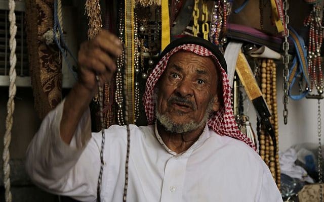 In this photo taken on April. 22, 2015, A Saudi vendor displays beads to customers at a market in Najran, Saudi Arabia. (AP Photo/Hasan Jamali)