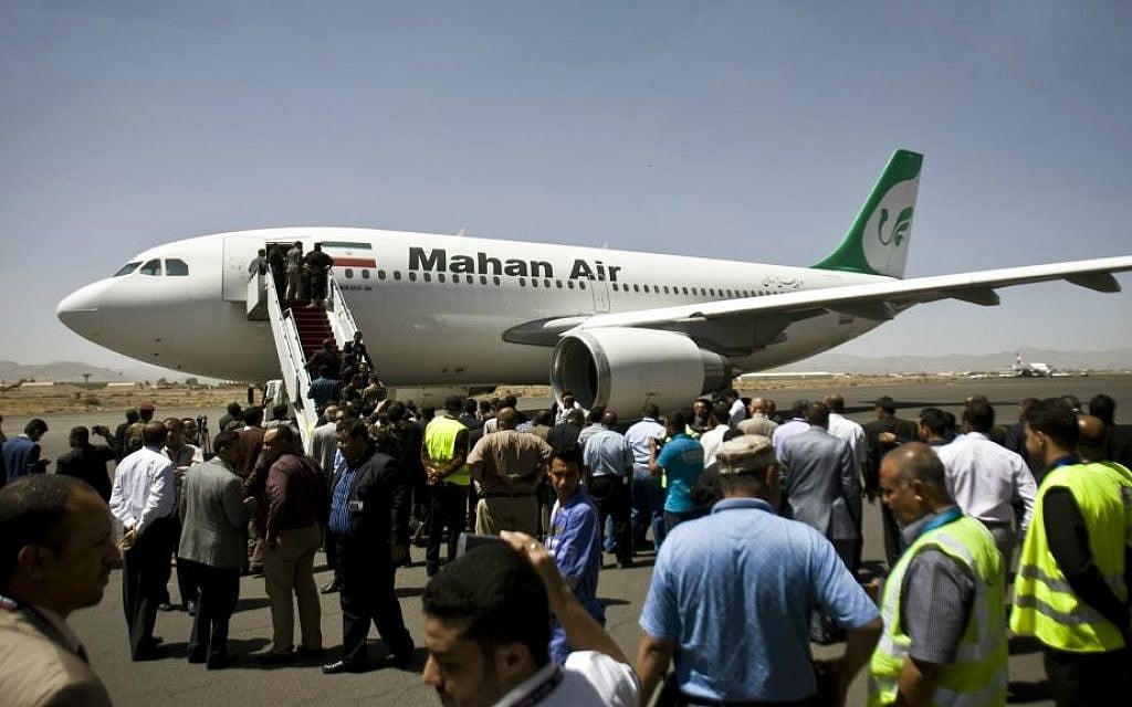 In this March 1, 2015 file photo, Yemeni airport, security and transportation officials greet a plane from the Iranian private airline Mahan Air after it lands in Sanaa, Yemen. (AP Photo/Hani Mohammed, File)
