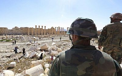 In this picture taken Friday, April 1, 2016, soldiers look over damage at the historical Bel Temple in the ancient city of Palmyra in the central city of Homs, Syria.  (AP)