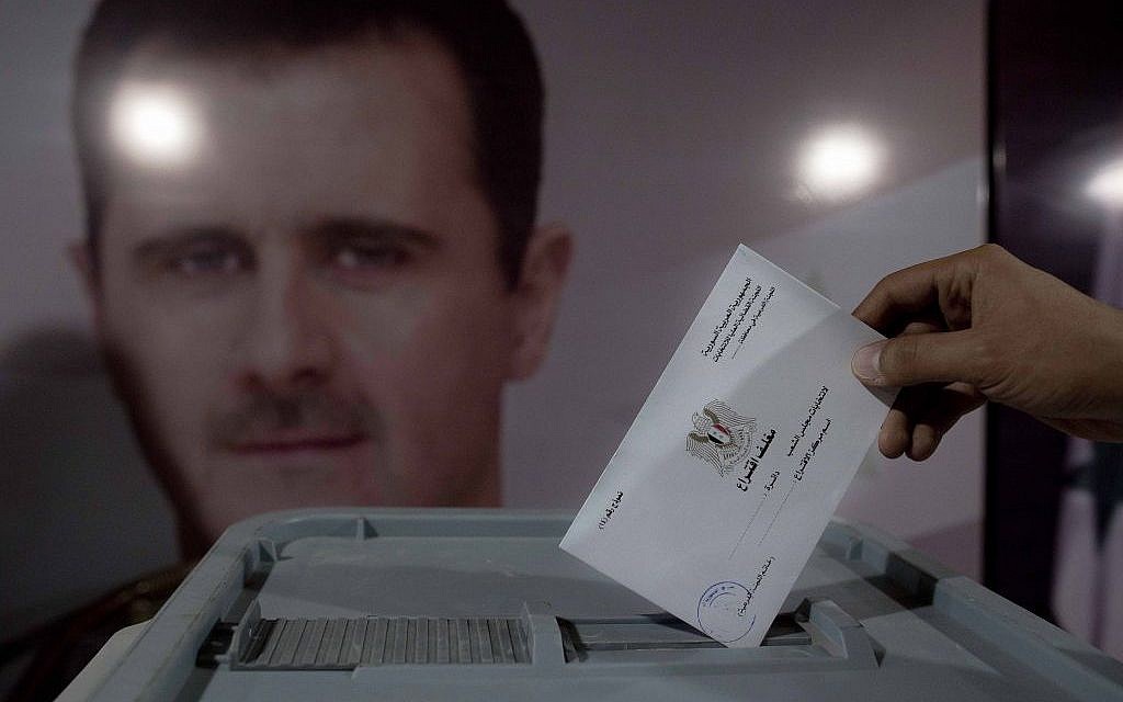A Syrian man casts his vote at a polling station during the parliamentary election in Damascus, Syria, Wednesday, April 13, 2016. (AP Photo/Hassan Ammar) A Syrian man casts his vote at a polling station during the parliamentary election in Damascus, Syria, Wednesday, April 13, 2016. (AP Photo/Hassan Ammar)