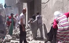 This image made from video released by Qasion News Agency, a media opposition platform that relies on a network of activists on the ground, on Friday, April 29, 2016 shows people scrambling through rubble following airstrikes in Aleppo, Syria. (Qasion News Agency via AP)