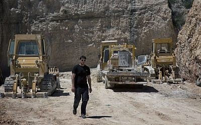 25 year-old, Alaa Al-Tawil, walks through a Palestinian quarry in the West Bank village of Beit Fajar, Bethlehem, April 19, 2016. (AP Photo/Nasser Nasser)