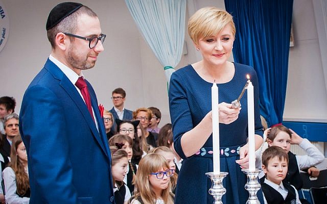 Polish First Lady Agata Duda lights candles with Pawlak during a visit to the school (courtesy)