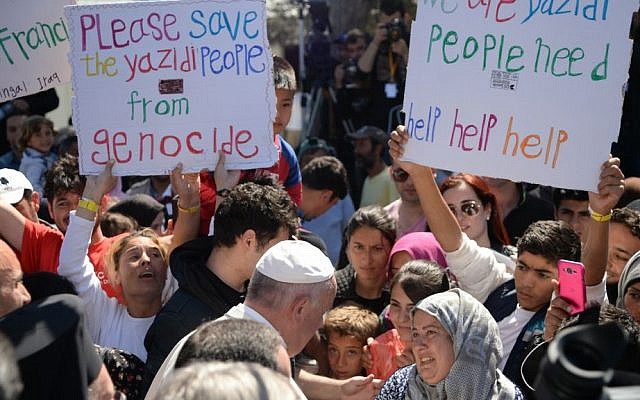 Pope Francis greets migrants and refugees at the Moria refugee camp, on the Greek island of Lesbos, Saturday, April 16, 2016. (Filippo Monteforte/Pool Photo via AP)