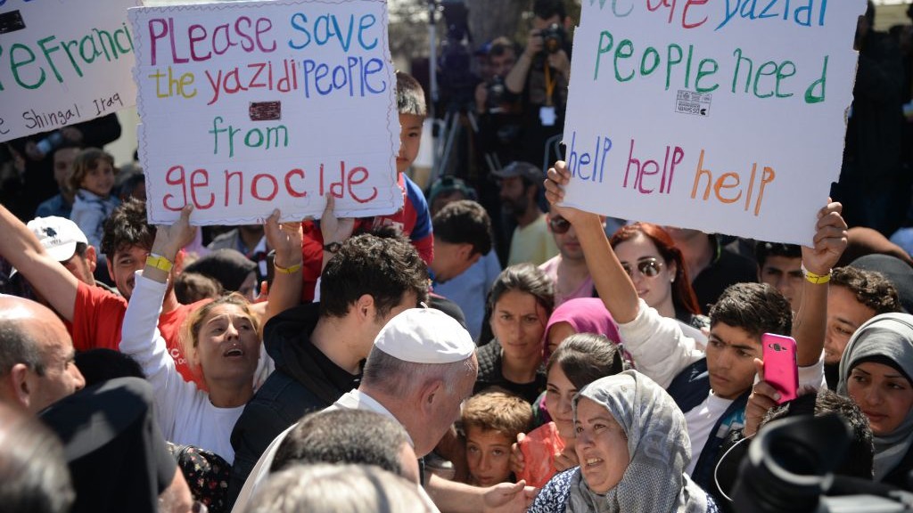 Pope Francis greets migrants and refugees at the Moria refugee camp, on the Greek island of Lesbos, Saturday, April 16, 2016. (Filippo Monteforte/Pool Photo via AP) Pope Francis greets migrants and refugees at the Moria refugee camp, on the Greek island of Lesbos, Saturday, April 16, 2016. (Filippo Monteforte/Pool Photo via AP)