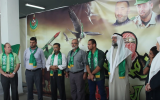 Screen shot taken from a speech by Dr. Imad al-Barghouthi at Hamas rally at al-Quds University in Jerusalem in October 2014.  He is standing on the far left, and is flanked by a poster honoring Hamas' military wing.  (screen capture: YouTube)