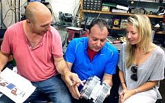 (L to R) Shaul Yaakoby, CTO and Inventor, Gal Fridman, CMO and Maya Gonik, Head of Business Development check out an Aquarius engine (Courtesy)