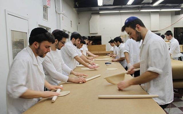 Matzah dough is rolled into thin, round discs before it is perforated and baked. Every 15 minutes at the Satmar Bakery in Brooklyn, the work ceases while all surfaces are scoured or replaced, and all hands are washed to remove stray bits of dough. (Uriel Heilman) Matzah dough is rolled into thin, round discs before it is perforated and baked. Every 15 minutes at the Satmar Bakery in Brooklyn, the work ceases while all surfaces are scoured or replaced, and all hands are washed to remove stray bits of dough. (Uriel Heilman/JTA)