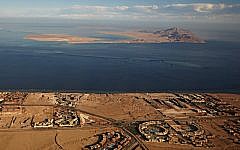 The Red Sea islands of Tiran, in the foreground, and Sanafir, in the background, sit at the the Strait of Tiran between Egypt’s Sinai Peninsula and Saudi Arabia (Stringer/AFP/Getty Images, via JTA)