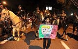 Police on horseback and on foot clear the anti-Trump demonstrators after a Republican presidential candidate Donald Trump rally at the Pacific Amphitheatre on Thursday, April 28, 2016, in Costa Mesa, Calif. (Michael Goulding/The Orange County Register via AP)