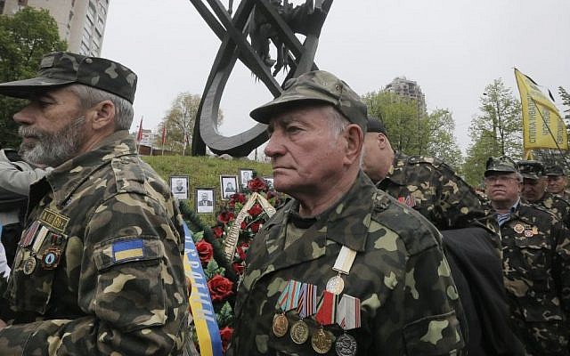 Chernobyl veterans bring flowers to commemorate victims of the Chernobyl nuclear disaster, during a ceremony at the memorial to Chernobyl workers and firefighters in Ukraine's capital Kiev, Ukraine, Tuesday, April 26, 2016.  (AP Photo/Efrem Lukatsky)