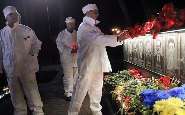 The Chernobyl nuclear plant workers in uniform attend a ceremony to commemorate victims of the Chernobyl nuclear disaster at the memorial to Chernobyl workers and firefighters in the town of Slavutych, Ukraine, early Tuesday, April 26, 2016. (AP Photo/Efrem Lukatsky)