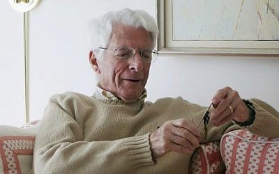 93-year-old Edwin Shifrin at home in Clayton, Missouri, in February 2016, looking at a prisoner-of-war medal he just received for his World War II military service. The award was expedited by US Sen. Claire McCaskill of Missouri after she was approached by Shifrin's family about his clever escape from a Nazi prison camp. (Marianne Shifrin/Dan Shifrin via AP)