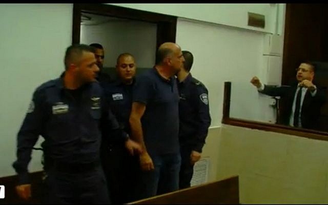 Hanan Abramovich being led into court for an arraignment hearing on April 20, 2016. (screen capture: Walla)