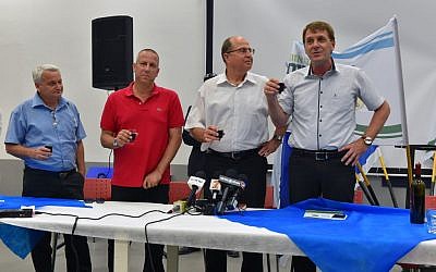 Eshkol regional council leader Tamir Idan, right, Defense Minister Moshe Ya'alon, center, and members of the local government raise a toast in honor of the approaching Passover holiday in southern Israel on April 18, 2016. (Ariel Hermoni/Defense Ministry)