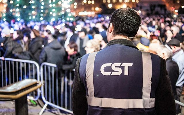 Illustrative: A Community Security Trust guard keeping watch over a Hanukkah celebration in London in 2014. (Blake Ezra Photography via JTA) Illustrative: A Community Security Trust guard keeping watch over a Hanukkah celebration in London in 2014. (Blake Ezra Photography via JTA)
