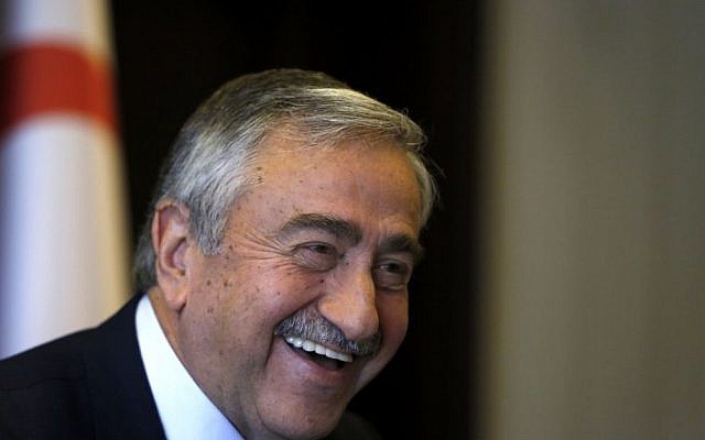 Turkish Cypriot leader Mustafa Akinci smiles is seen at his office during an interview for the Associated Press in the Turkish breakaway north part of the divided capital Nicosia in this ethnically Mediterranean island of Cyprus, Monday, April 4, 2016. (AP Photo/Petros Karadjias).