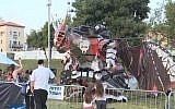 Visitors watch the dragon robot at the Geek PicNic held in Jerusalem during Passover 2016. (screen capture: YouTube)
