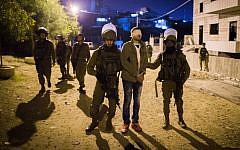 Illustrative: IDF soldiers arrest a Palestinian man in the Dheisheh refugee camp, near the West Bank city of Bethlehem, on December 8, 2015. (Nati Shohat/Flash90)