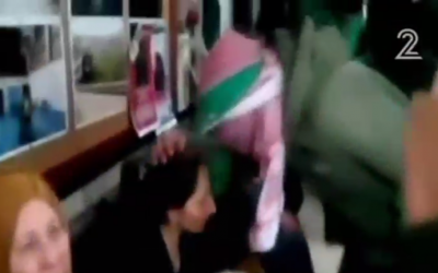 Hamas gunmen kiss the head of Azhar Abu Srour, mother of the suicide bomber who on April 18 blew up a bus in Jerusalem (Channel 2 screenshot)