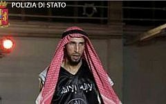 In an image released April 28, 2016, by Italian police, kickboxer Abderrahim Moutaharrik is seen wearing boxing gloves, shorts, a keffiyeh and a black shirt styled after the IS flag. (Italian Police)