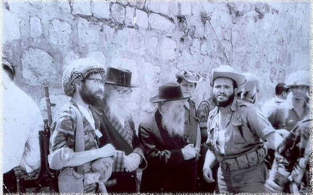 Gathering at the Western Wall to express thanks and gratitude. From left to right: Rabbi Yisrael Ariel (in combat helmet), the Nazarite, Rabbi David Cohen, and Rabbi Zvi Yehuda Kook. (The Temple Institute) Gathering at the Western Wall to express thanks and gratitude. From left to right: Rabbi Yisrael Ariel (in combat helmet), the Nazarite, Rabbi David Cohen, and Rabbi Zvi Yehuda Kook. (The Temple Institute)