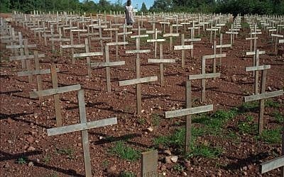 A young Rwandan girl walks through Nyaza cemetery outside Kigali, Rwanda, on Monday November 25, 1996, where thousands of victims of the 1994 genocide are buried (AP Photo/Ricardo Mazalan)